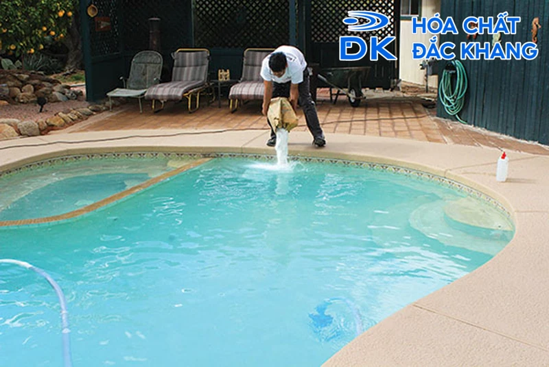 A person pouring water into a poolDescription automatically generated