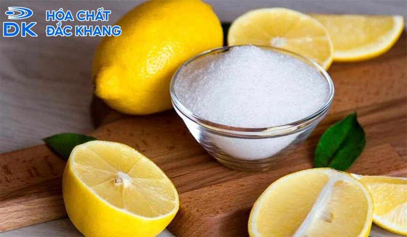 A bowl of salt next to lemonsDescription automatically generated